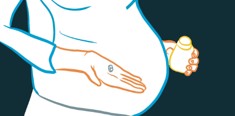 Une femme enceinte tiens un comprimé d'acide folique entre ses doigts